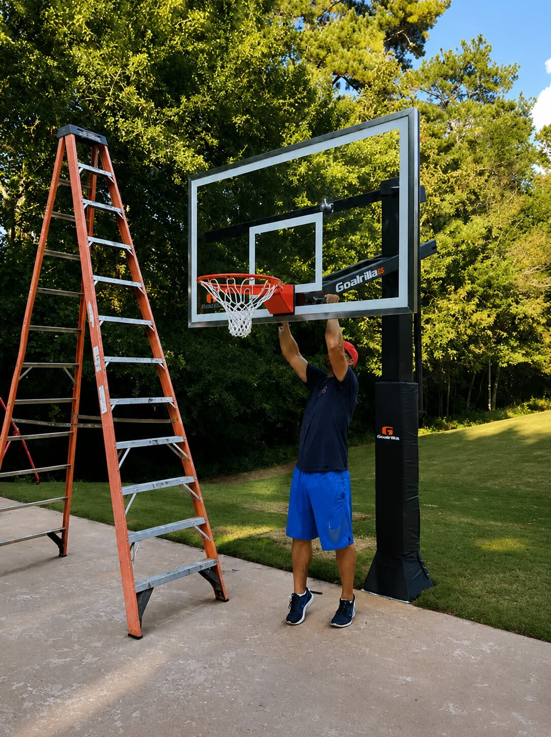 Technician on a ladder completing the rim and backboard installation
